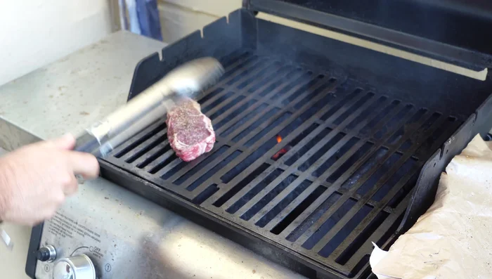 Place steaks on the hot grill at a 45-degree angle, pressing down to ensure good contact. Listen for the sizzle!