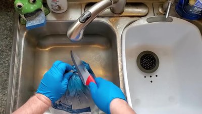 Rinse the turkey and prepare it for grilling (tuck skin, reconnect legs).