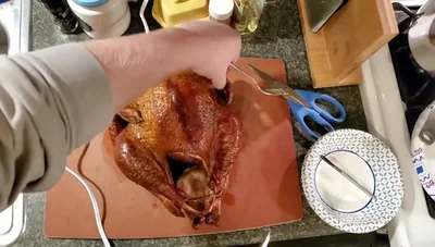 Carve the turkey. (Note: The video suggests watching another video for carving instructions).