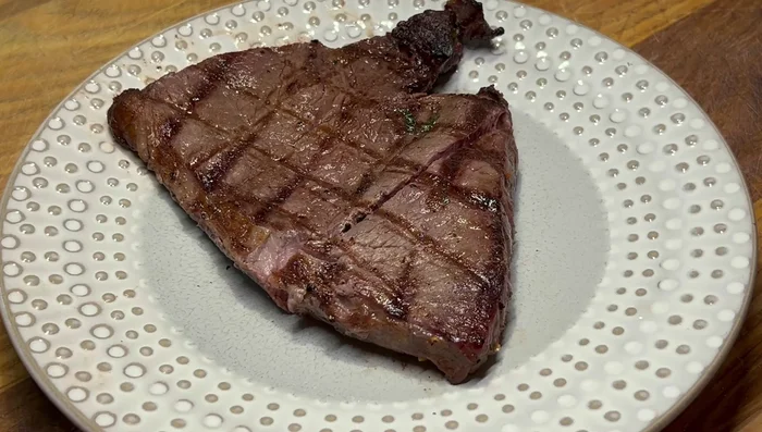 Remove the steak from the grill and let it rest for about 8 minutes before slicing.