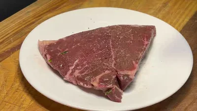 Season the steak with kosher salt, black pepper, and Spike seasoning on both sides.