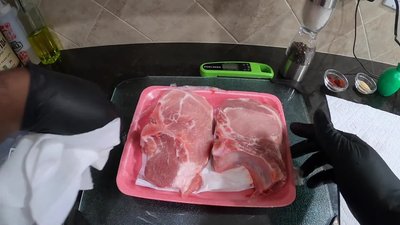 Rub smoked paprika all over the pork chops.