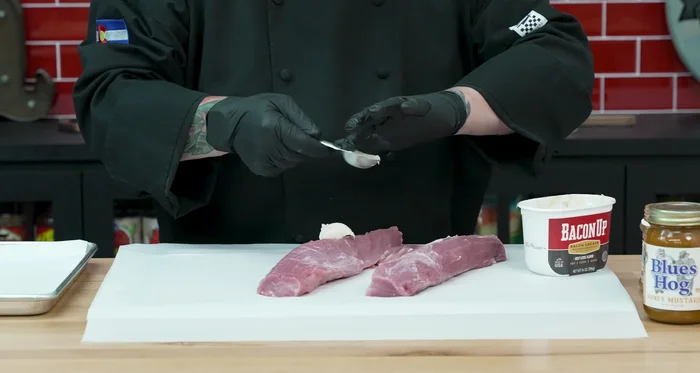 Apply a tablespoon of bacon grease to each tenderloin, coating evenly. Roll the tenderloins in the grease on the paper towels to remove excess.