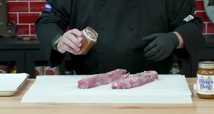 Season the tenderloins with Oink rub, ensuring complete coverage.