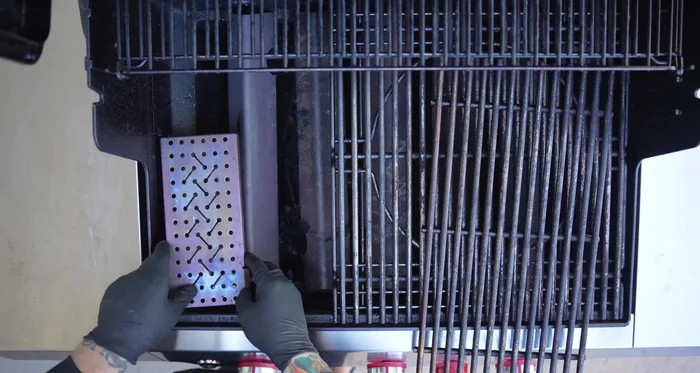 Preheat the Weber gas grill to 400°F. Place the smoker box with apple wood chips on top of the flavorizer bars.