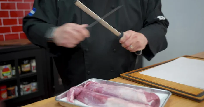 Trim the silver skin from the pork tenderloins using a sharp knife. Wiggle the knife under the skin and carefully remove it.