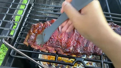 Brush barbecue sauce on the ribs, wrap in heavy-duty foil, and cook until the internal temperature reaches 200°F.