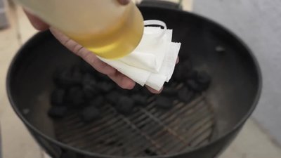 Stir up the charcoal and place the grill grate on.