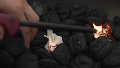 Stir up the charcoal and place the grill grate on.