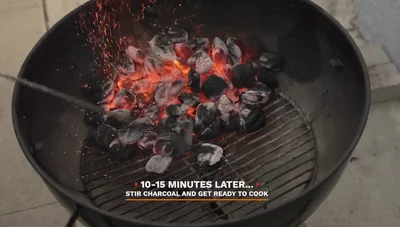 Stir up the charcoal and place the grill grate on.