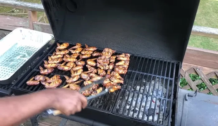 Remove chicken wings from grill and serve.