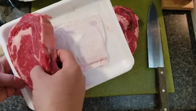 Season with salt, pepper, and garlic powder. Pat the seasoning into the meat.