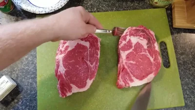 Season with salt, pepper, and garlic powder. Pat the seasoning into the meat.