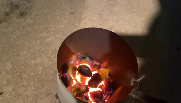 Prepare the smoker: Set up a snake method charcoal arrangement with hickory wood chunks.