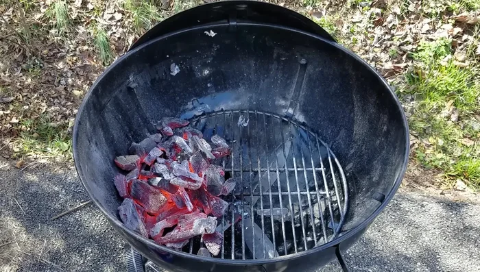 Pour the hot coals onto one side of the grill (two-zone fire).