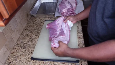 Rub the ribs with olive oil, Lowry seasoned salt, onion powder, garlic powder, and black pepper.