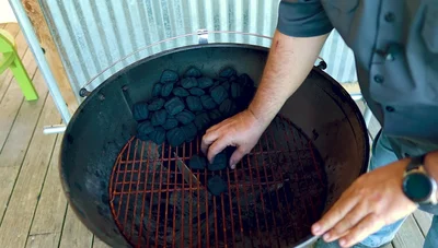 Dump lit briquettes onto the edge of the unlit stack.