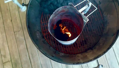 Dump lit briquettes onto the edge of the unlit stack.