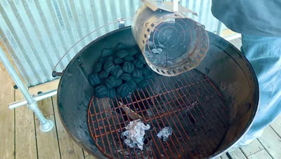 Dump lit briquettes onto the edge of the unlit stack.