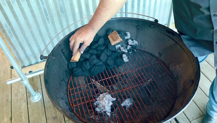 Place smoke wood on top of lit charcoal.
