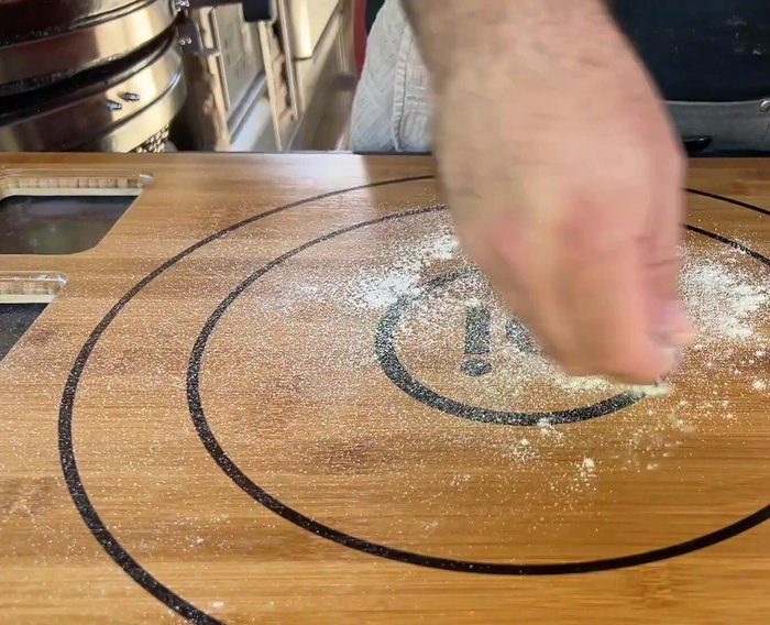 Prepare the pizza dough (recipe provided in video description).