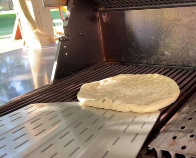 Cook for 90 seconds on high, then reduce burners directly under the pizza to medium to prevent burning.