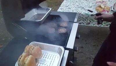 Season the burgers again while they grill on the second side.