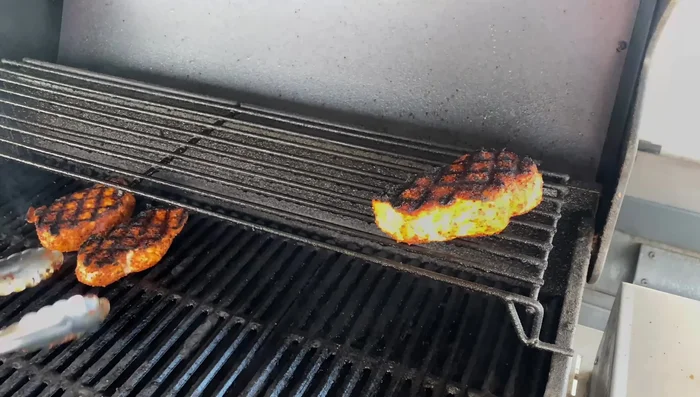 Finish Cooking: Move pork chops to the top rack (if available), turn off one side of the grill to reduce direct heat. Cook until internal temperature reaches 145°F, using an instant-read thermometer.