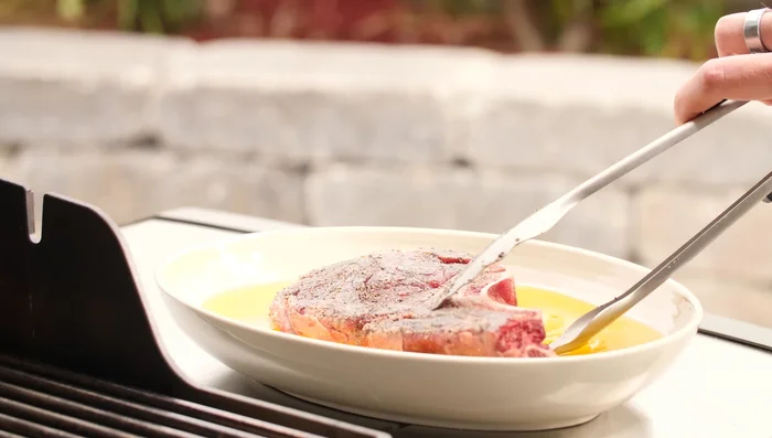 Place the steak on the hot grill grates. Sear for 2 minutes per side, then crosshatch by turning the steak 45 degrees and searing for another 2 minutes per side. This creates a beautiful sear and good grill marks.