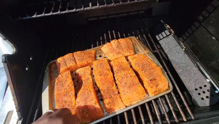 Grill the salmon: Place the oiled grill pan directly on the grill grates. Grill for 15-20 minutes, rotating halfway through. Continue grilling until the salmon flakes easily and the skin is crispy (another 10-15 minutes).