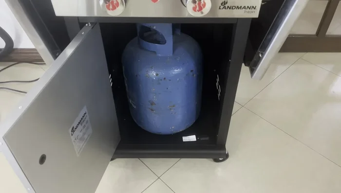 Connect the LPG gas tank to the grill. Ensure the tank is a regular size (not a special size).