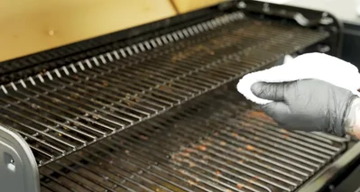 Spray the top of the grates with a food-contact surface approved cleaner and wipe down with a towel to remove residue and oils.