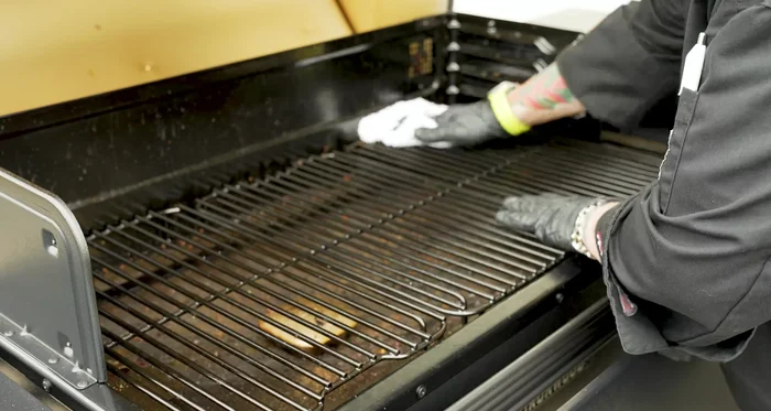 Use a damp towel with warm water to wipe down the grates, removing any remaining residue.