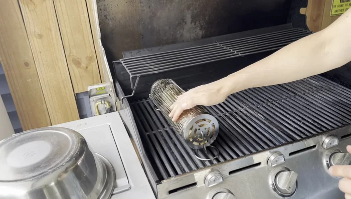 Allow the food to cook, turning manually with tongs if necessary, or using the rolling function of the grill baskets.