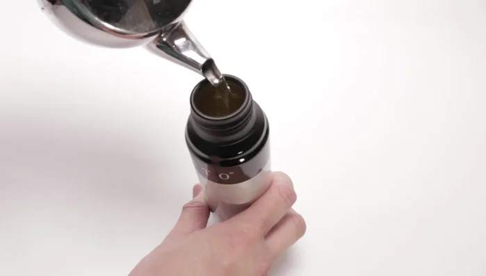 Fill the sprayer halfway with olive oil.