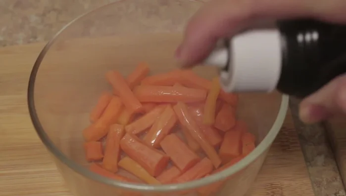 Toss the vegetables gently to distribute the oil evenly.