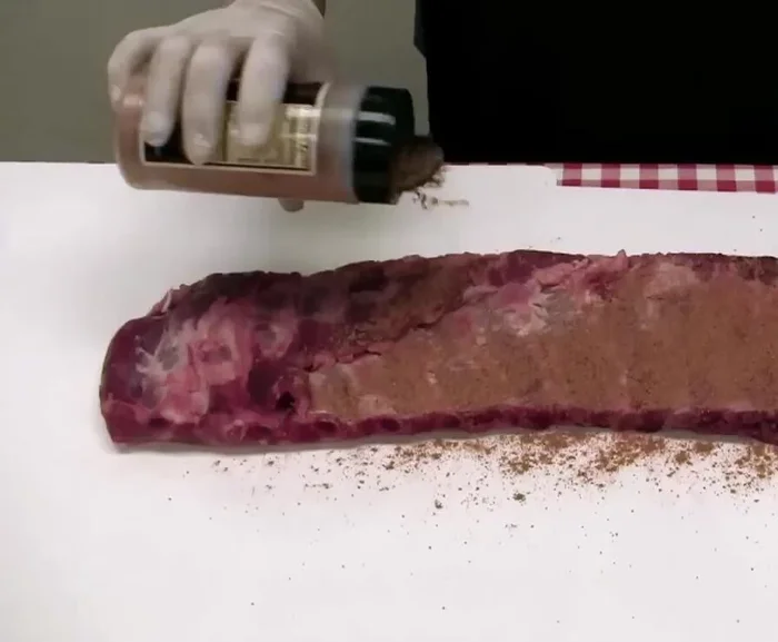 Apply the rib rub: Generously coat both sides of the ribs with Cook Shack rib rub.