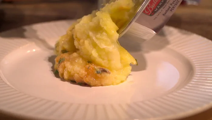 Plate the elk rack on mashed potatoes, surrounded by brussels sprouts and bacon.