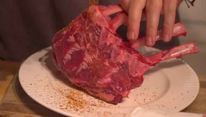 Season the elk rack evenly with red eye express coffee infused seasoning.