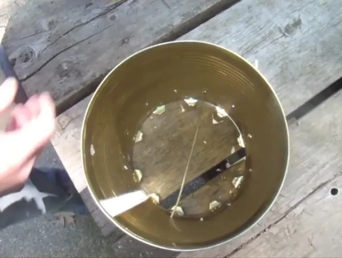 Bend the ends of the coat hanger wire segments on the opposite side to secure the grate.