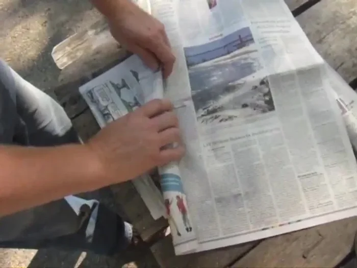 Roll up newspaper and place it at the bottom of the can (under the church key tabs).