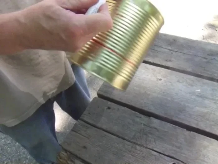 Drill corresponding holes in the can to match the handle's holes. You might need a pilot hole.