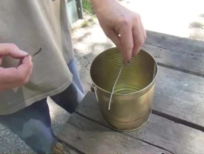 Bend the ends of the coat hanger wire segments on the opposite side to secure the grate.