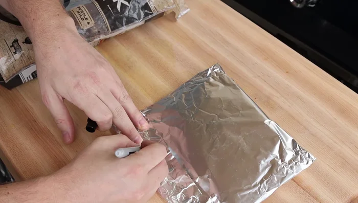 Poke several holes in the foil with a fork for smoke release.