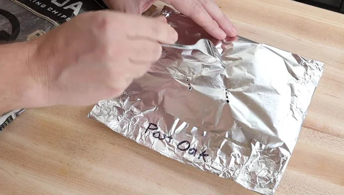Poke several holes in the foil with a fork for smoke release.
