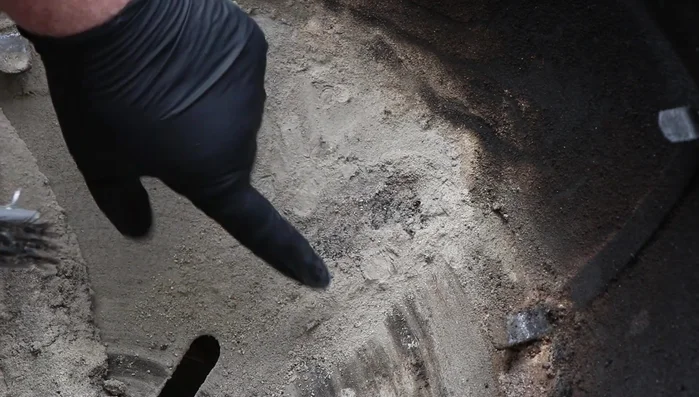 Scrape and brush away the congealed ash, grease, and other debris from the bottom of the grill.