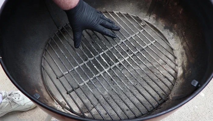 Remove the charcoal grate to access the bottom of the grill.