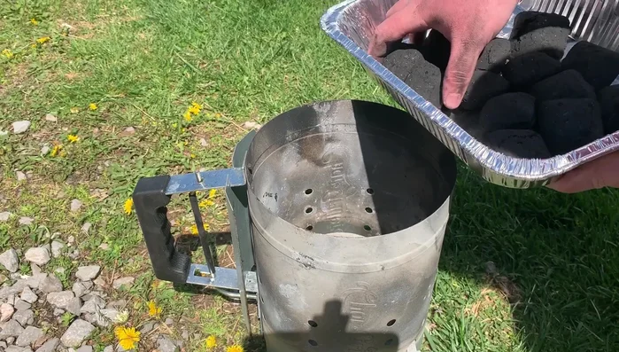 Place each type of charcoal into separate identical charcoal chimneys.