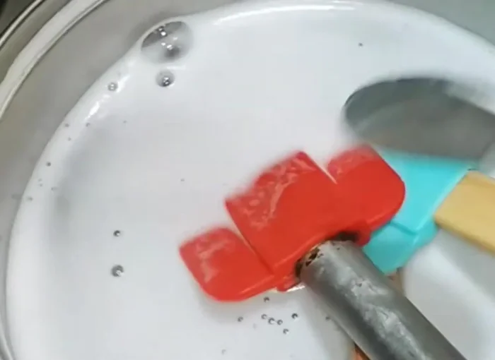 Let the utensils soak for at least an hour (or until the water cools).