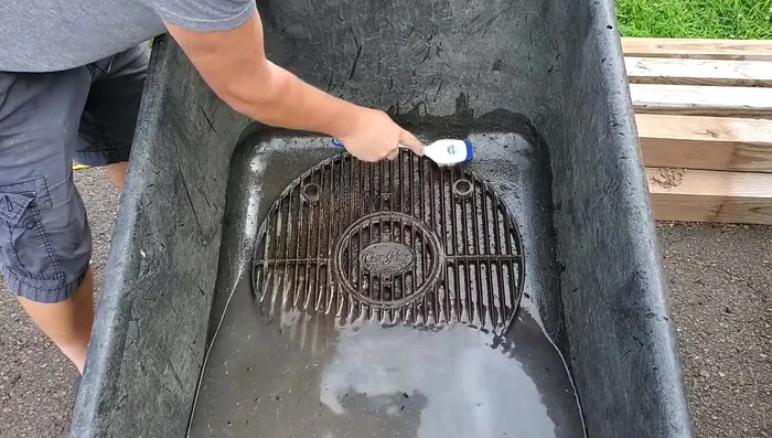 After soaking, scrub the grates with a nylon brush to remove loosened rust and debris.